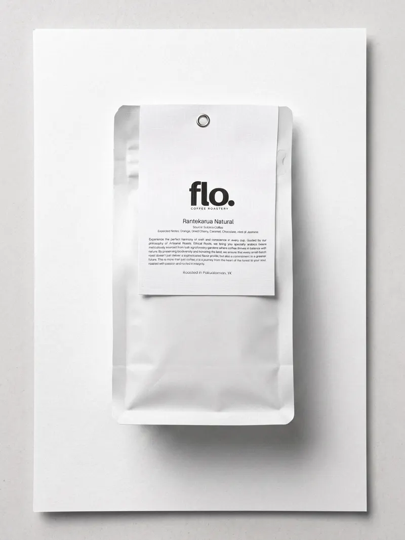 A flo. Rantekarua Natural pouch resting on a sheet of white paper.